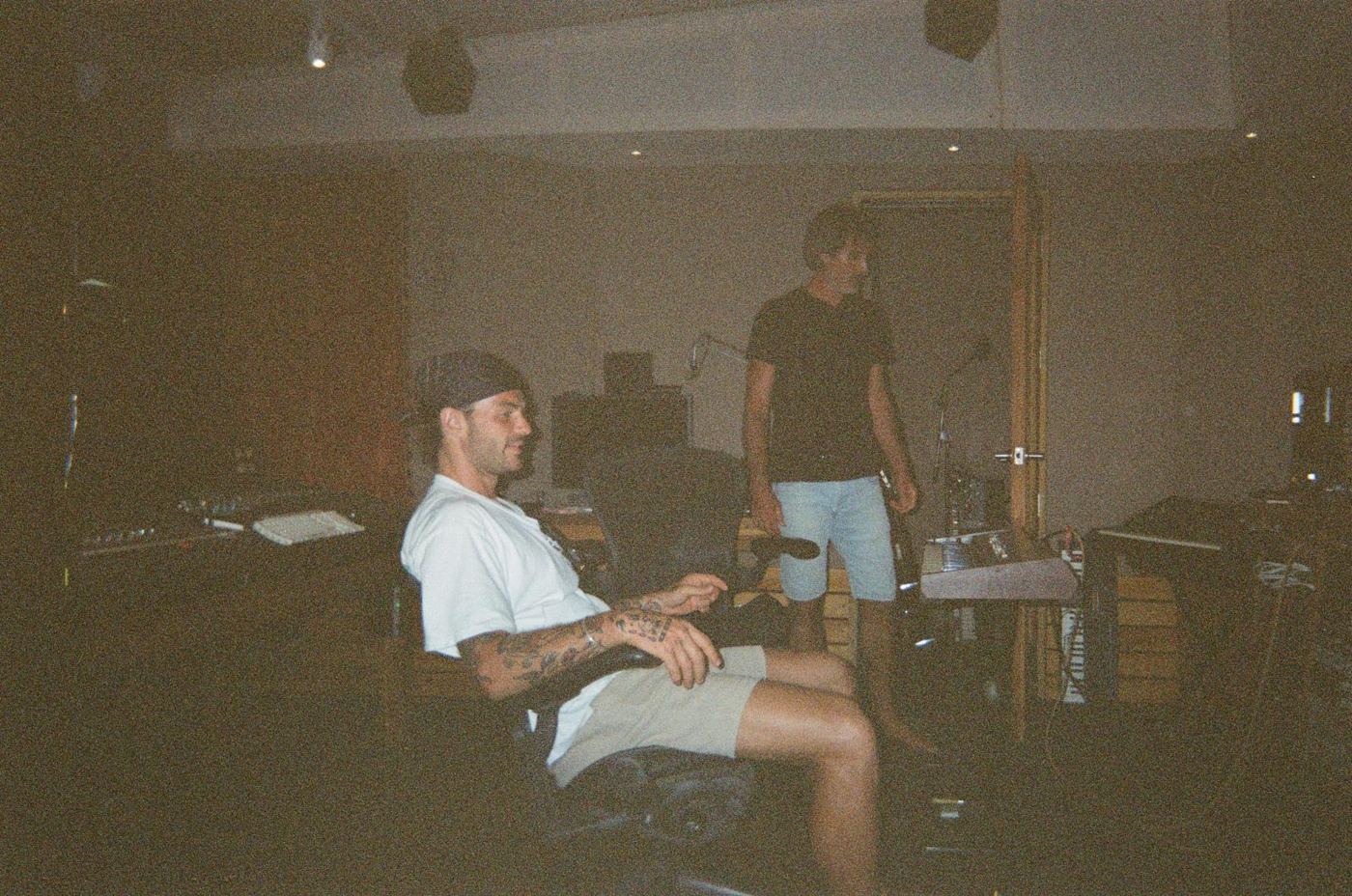 Two people relaxing in a recording studio