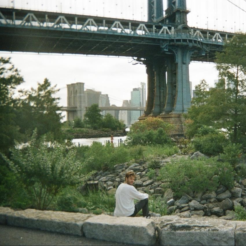 A city bridge over the river with the skyline beyond